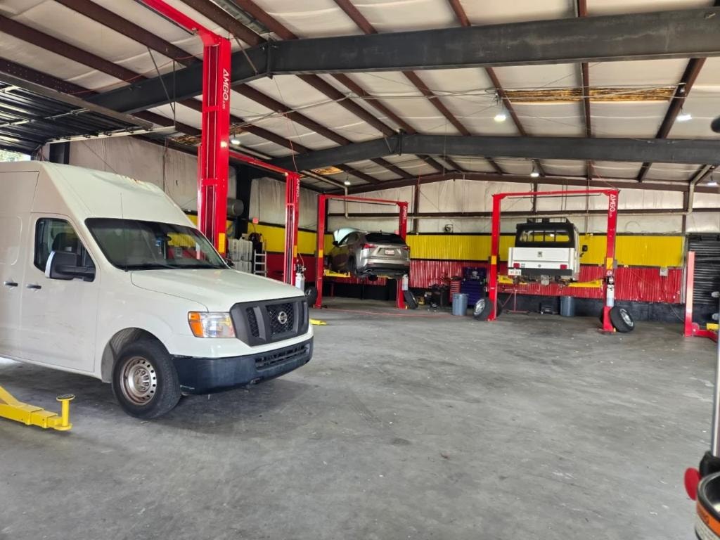 Vehicles on lifts in service bays — Guilbeau Road, Lafayette